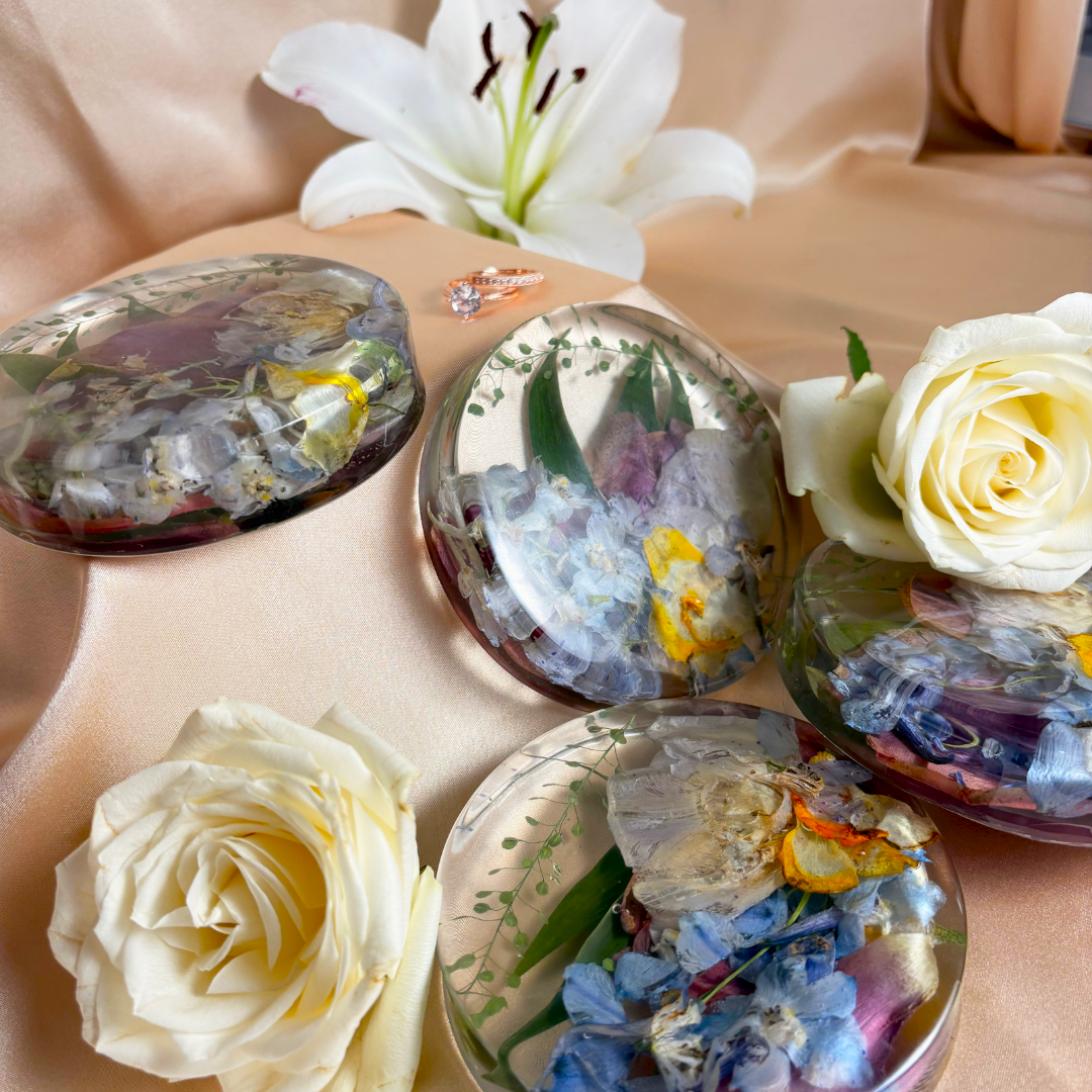 Set of four round resin coasters filled with blue and yellow flowers and eucalyptus leaves. Beautiful resin preservation of your bouquet.